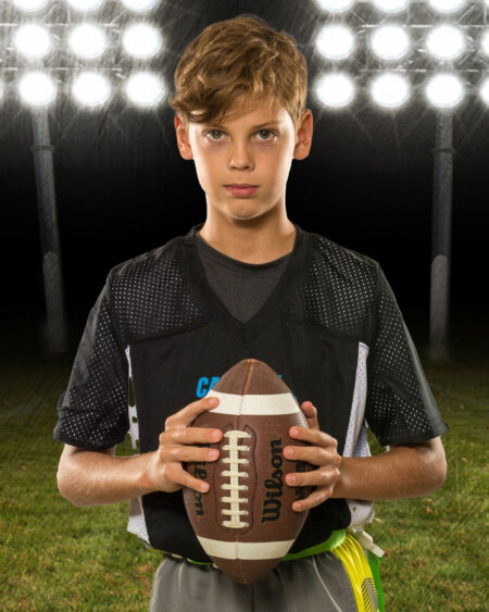 Youth Football with stadium lights background